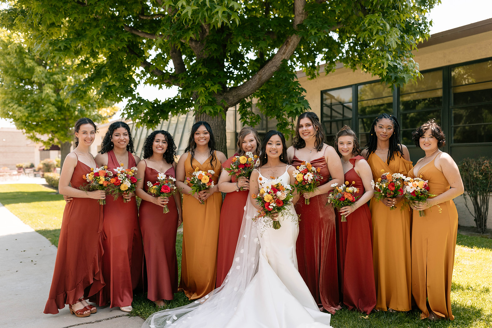 red yellow orange bridesmaid dresses flowing wedding train warm wedding bouquet red wedding bouquet california wedding
