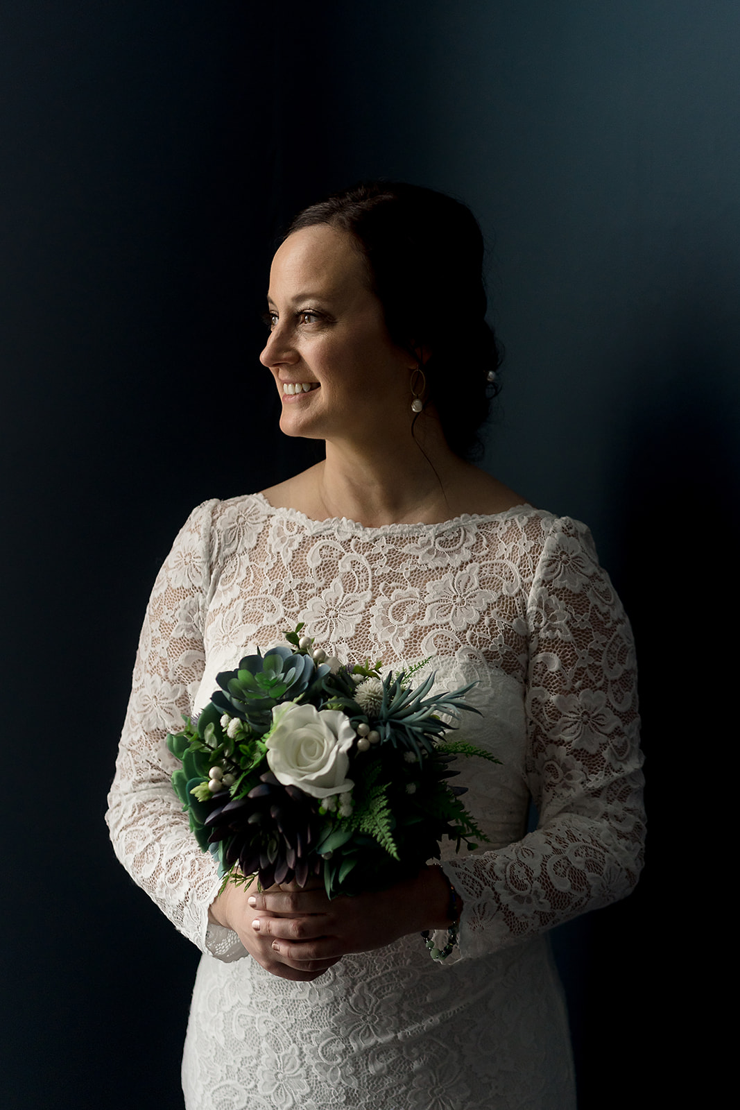 bride holds flowers bouquet at port gamble wedding