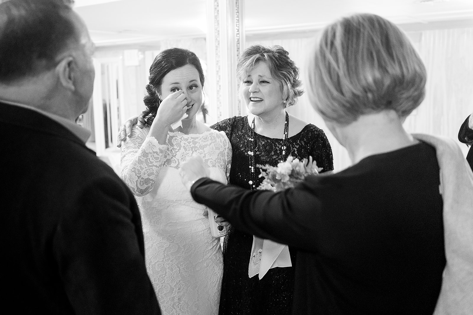 bride wipes away tears when talking with family at port gamble wedding