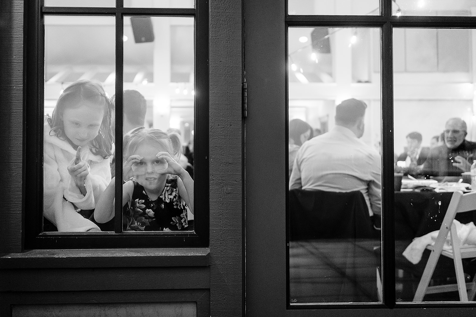 kids make faces in window at port gamble wedding reception