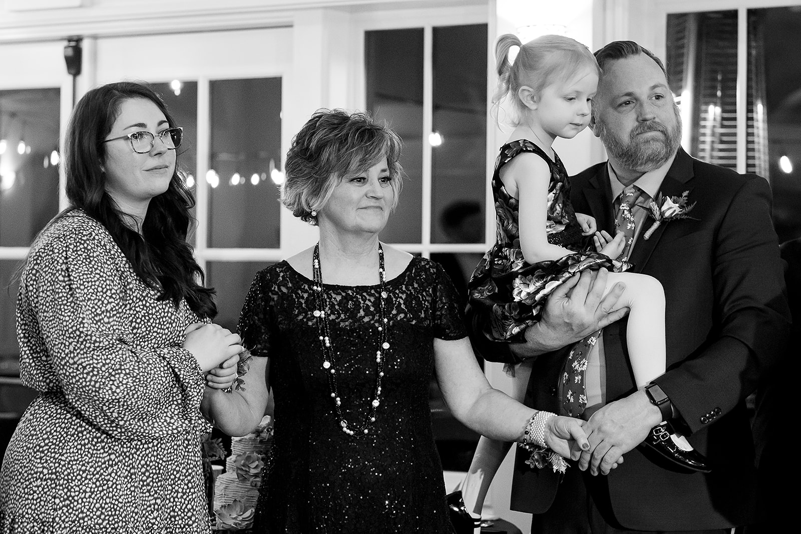 family cry while watching father and. groom at port gamble wedding reception