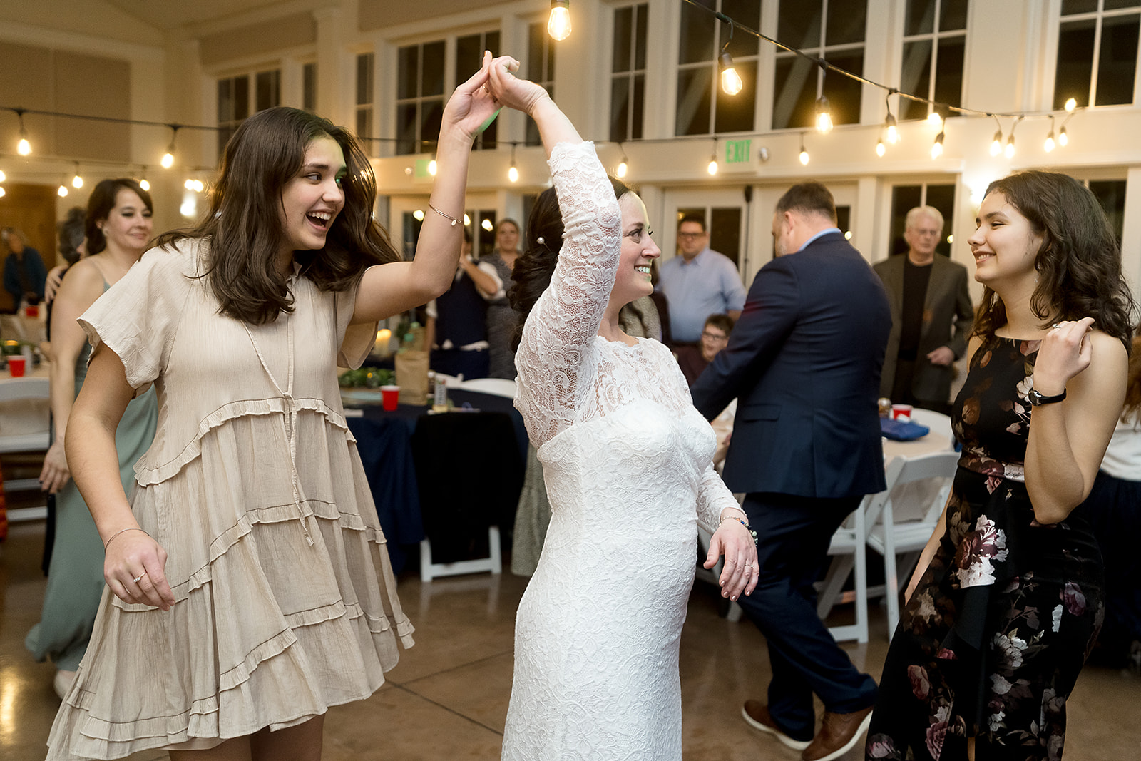 bride dances with family at port gamble wedding reception
