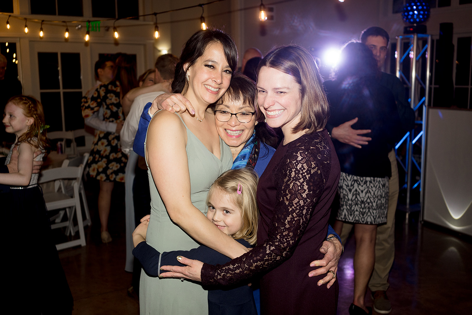 family embrace on the dance floor at port gamble wedding reception