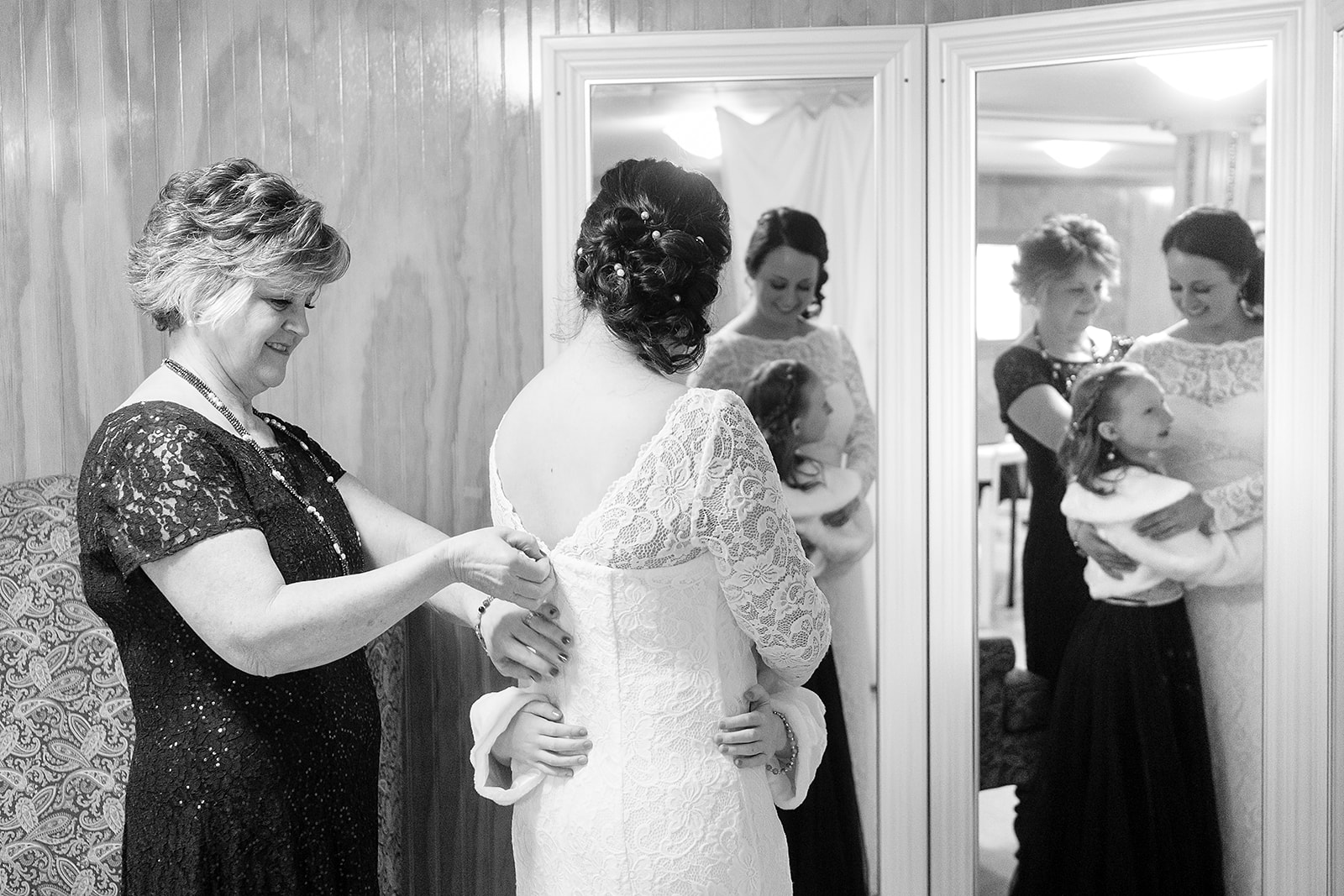 flower girl hugs bride while getting ready at port gamble wedding
