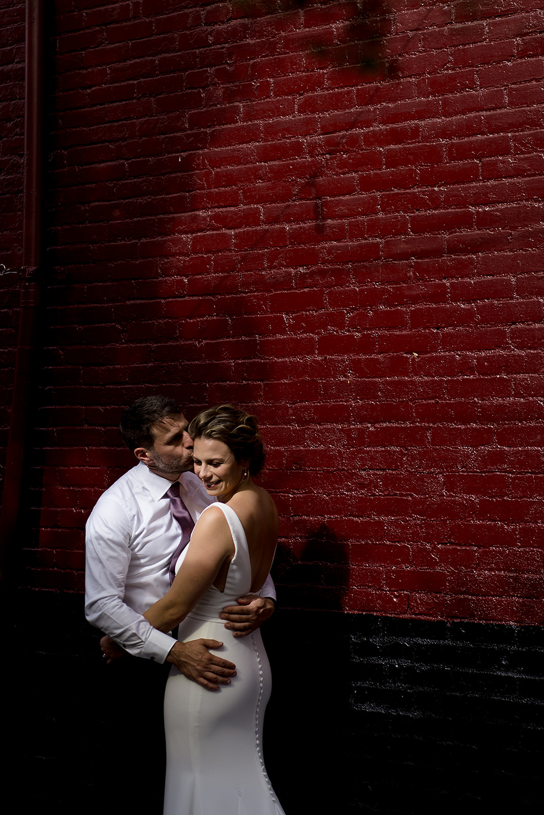 wedding portrait against red brick wall in Ballard
