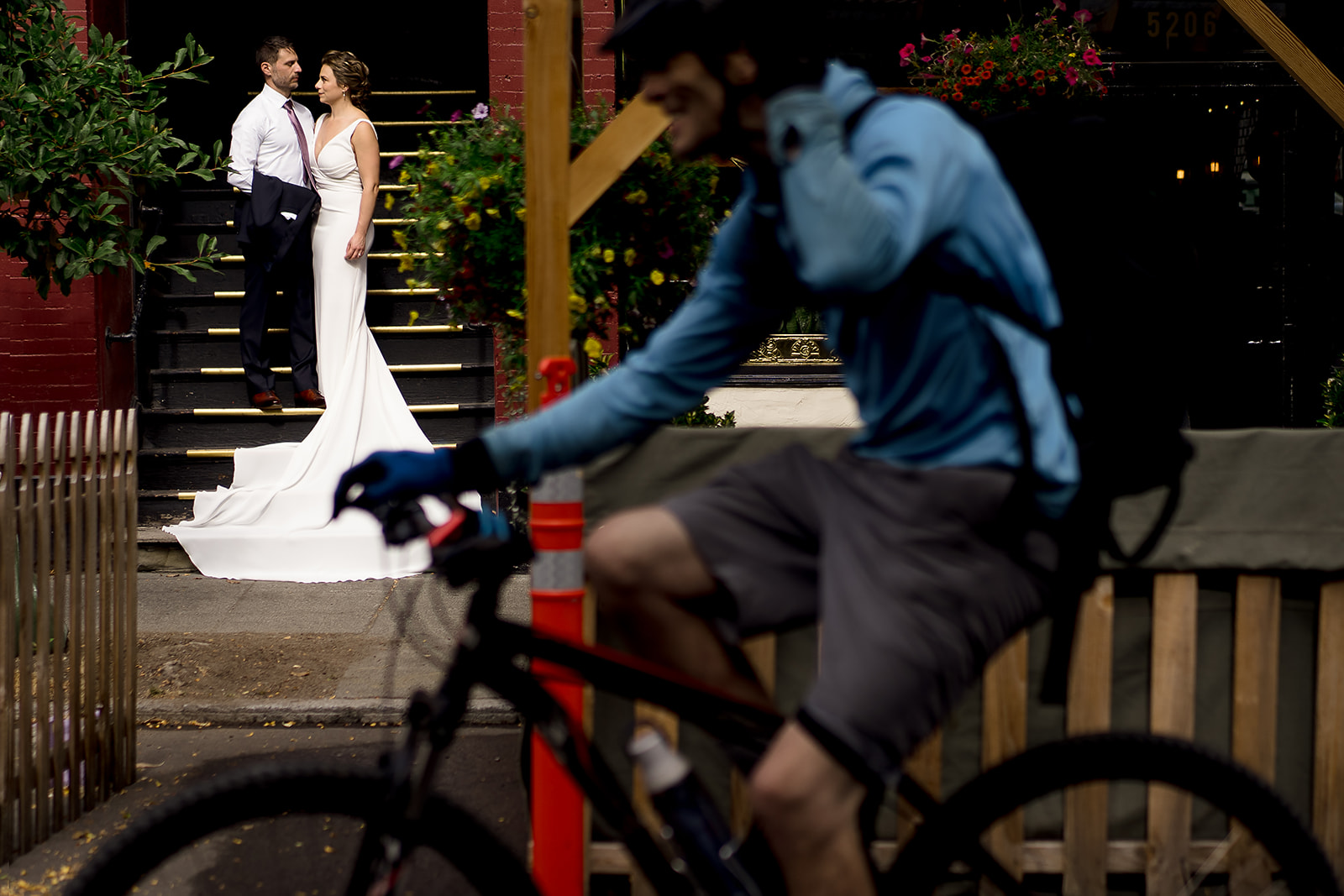 wedding portrait while biker rides by in Ballard.