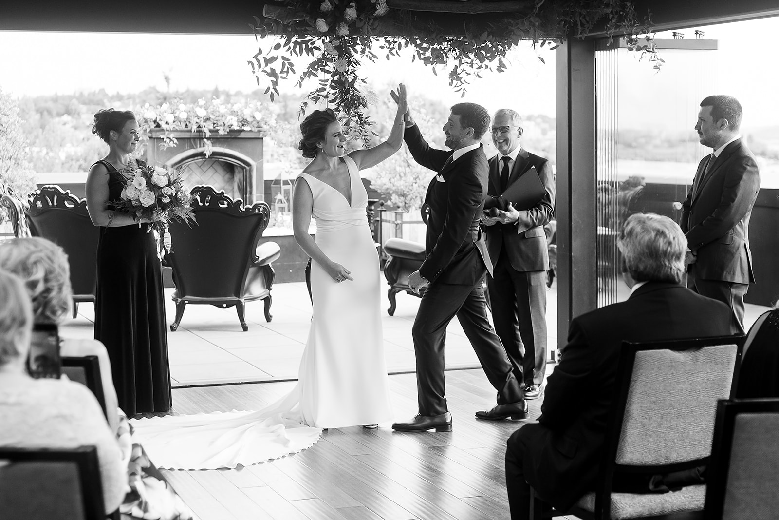 bride and groom high five each other at Hotel Ballard Olympic Rooftop Pavilion Wedding