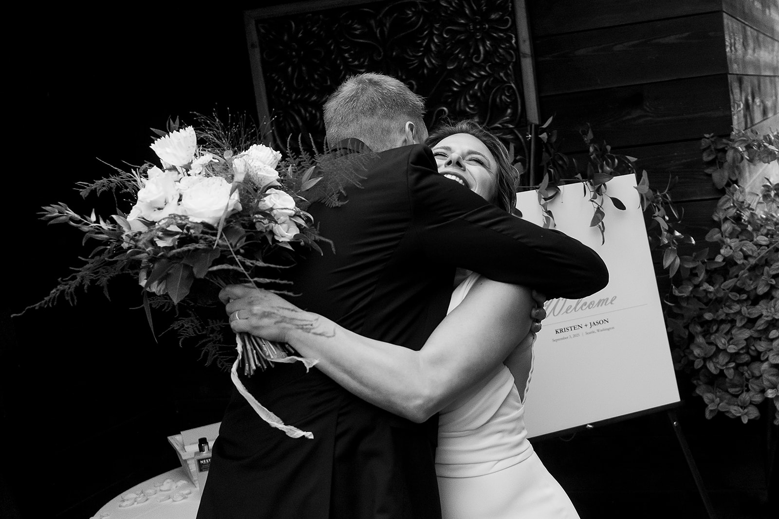 bride gets a big hug from guests after Olympic Rooftop Pavilion Wedding ceremony