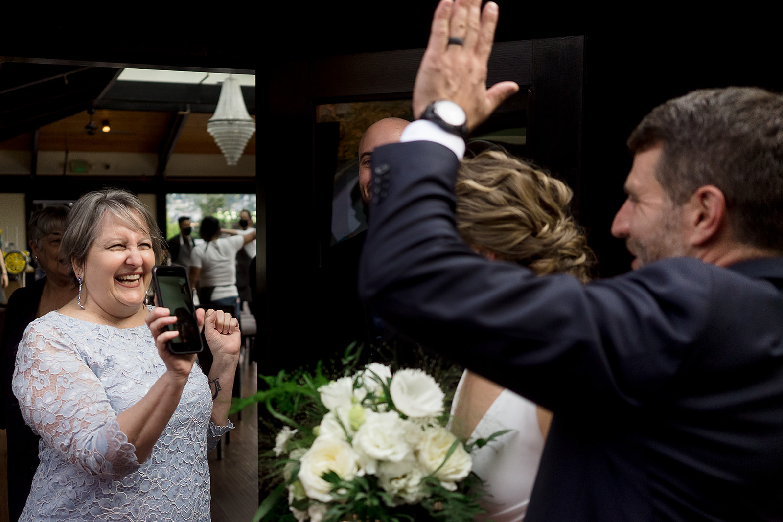 guests FaceTimes with wedding couple at Olympic Rooftop Pavilion Wedding