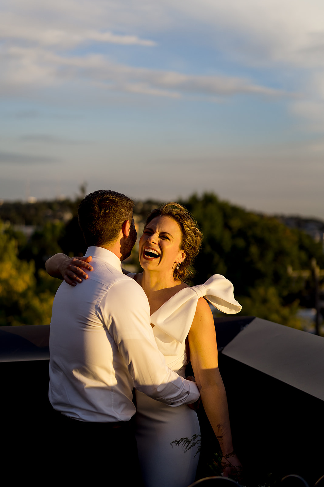 bride laughs at Hotel Ballard Olympic Rooftop Pavilion Wedding 