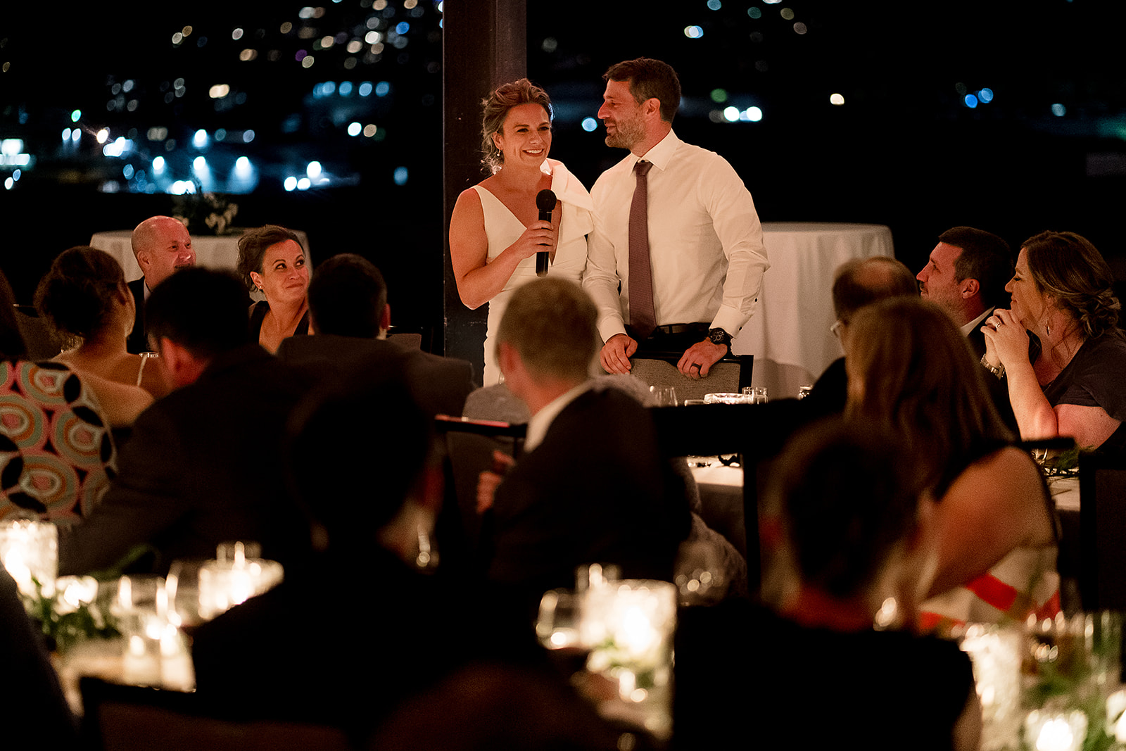 bride and groom give toast after dark at bride at Olympic Rooftop Pavilion