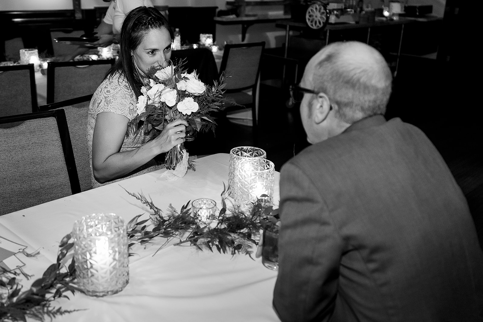 wedding guests smells bouquet of flowers after bouquet toss