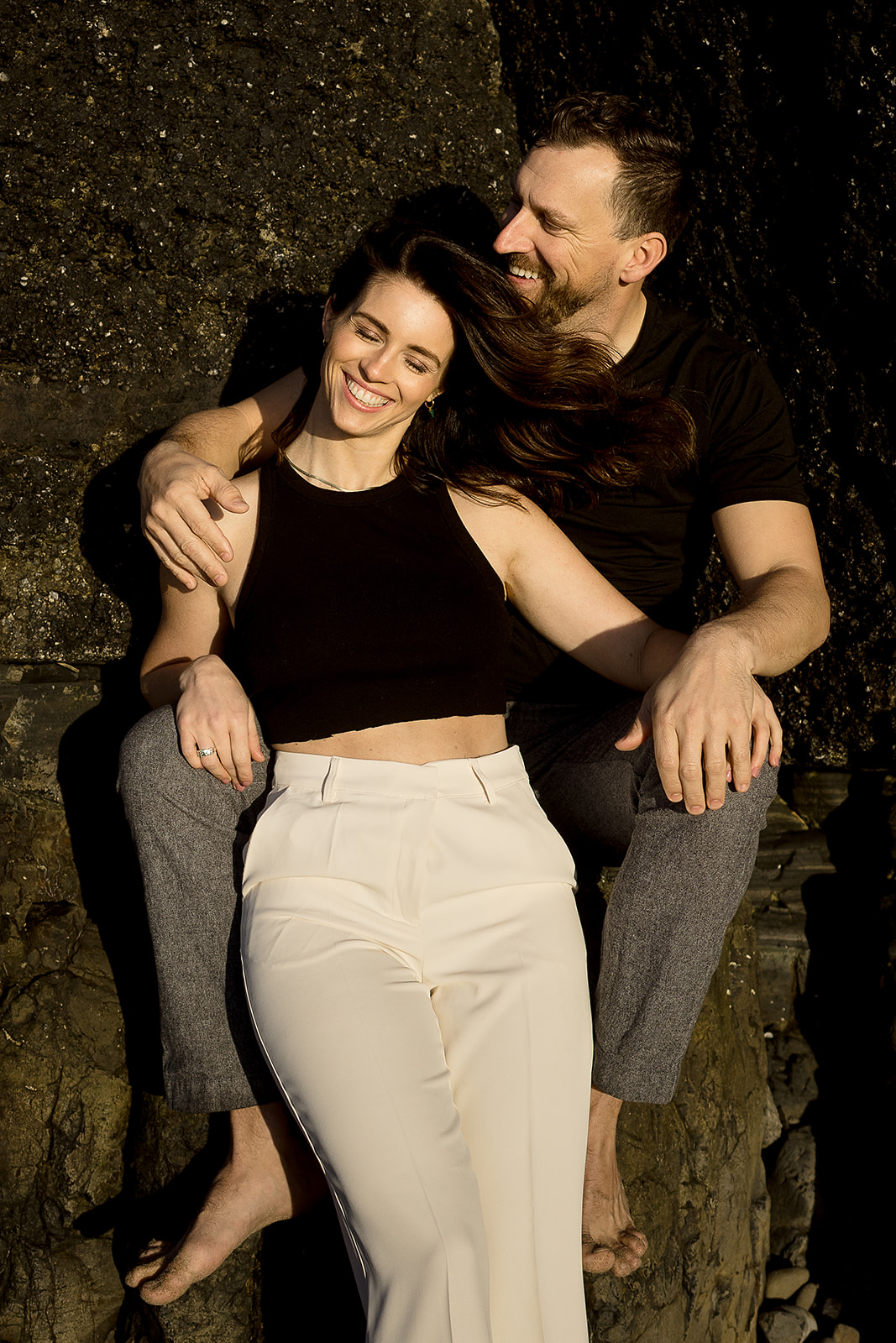 couple smiles while posing for couples portraits at their Cannon Beach Engagement session