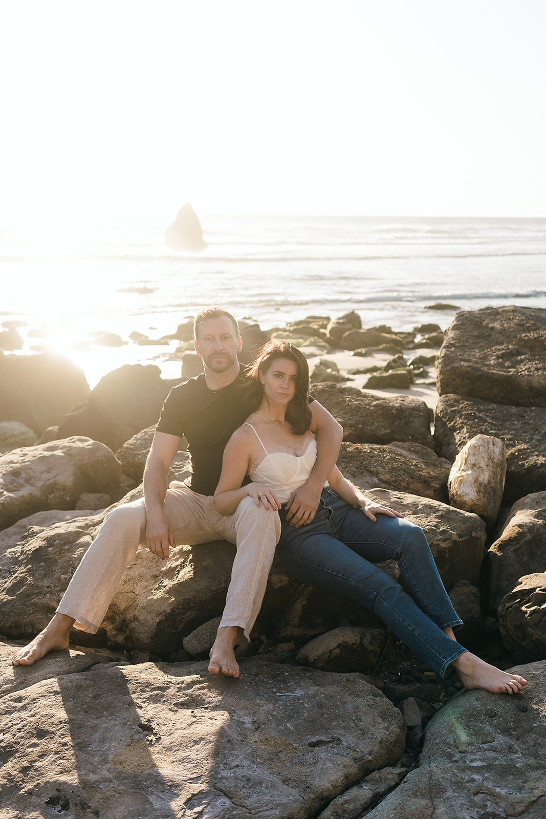 couple looks at the camera for poses Cannon Beach Engagement session