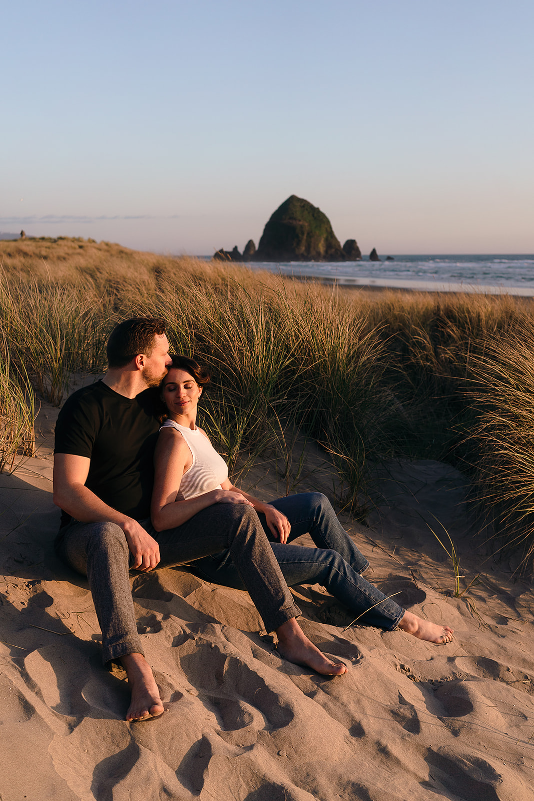 couple shares a quiet moment during sunset at Cannon Beach Engagement session