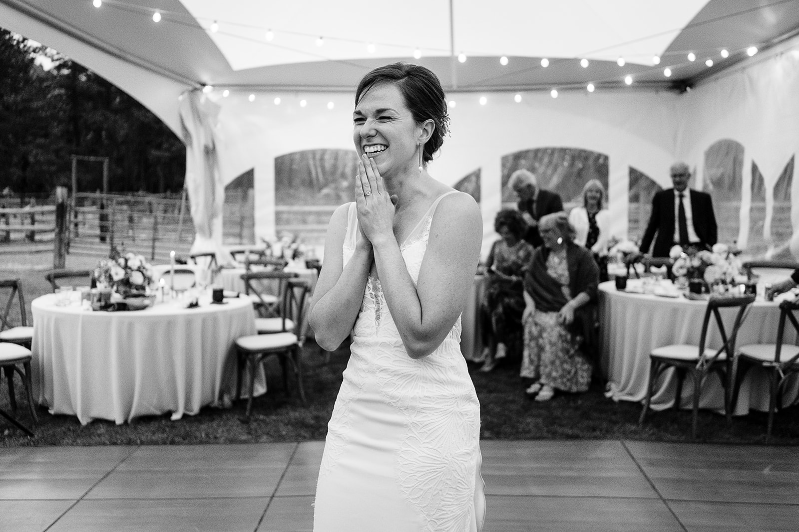 bride smiles and laughs during Mazama Ranch House Wedding reception