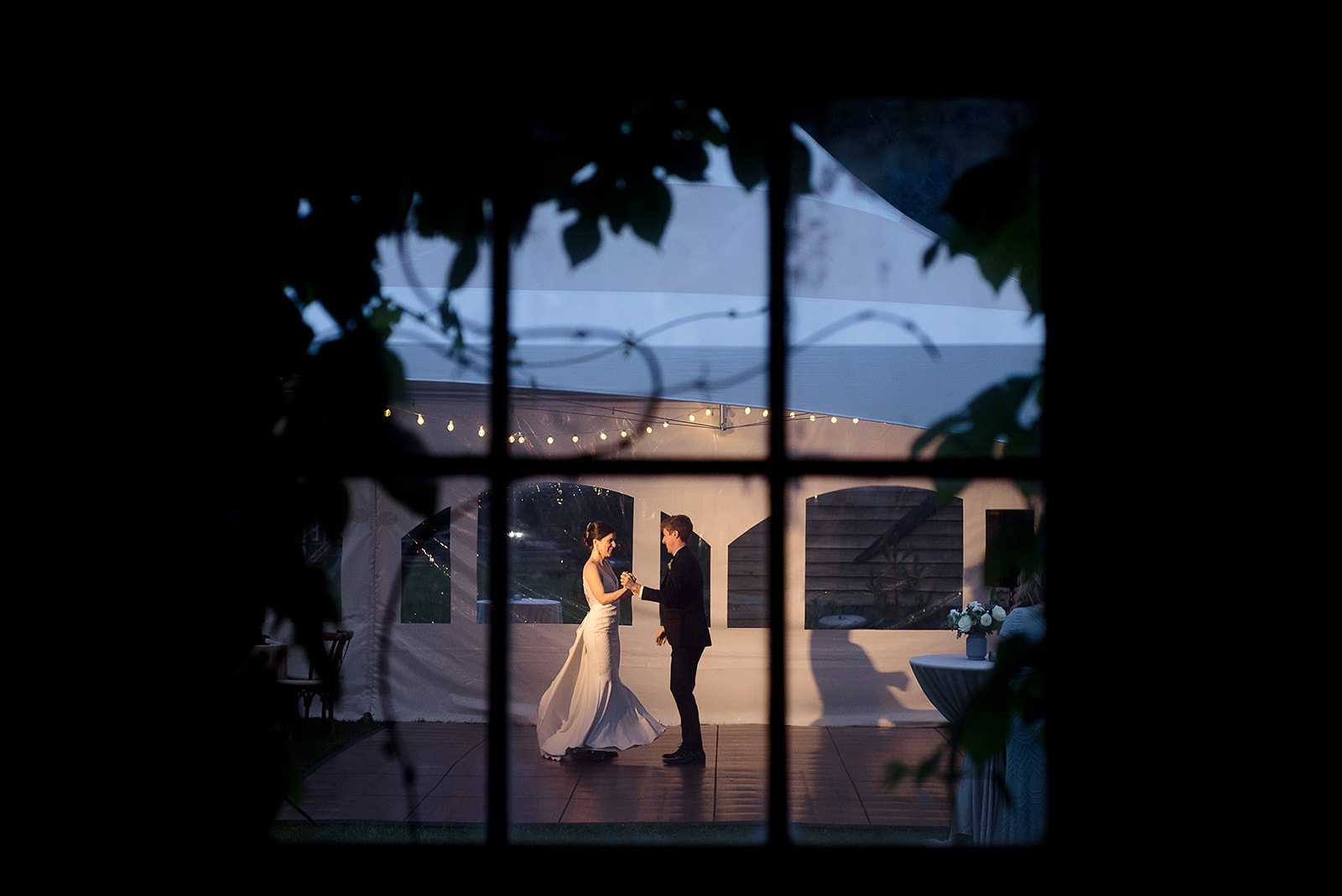 first dance photographed through barn window at Mazama Ranch House Wedding reception