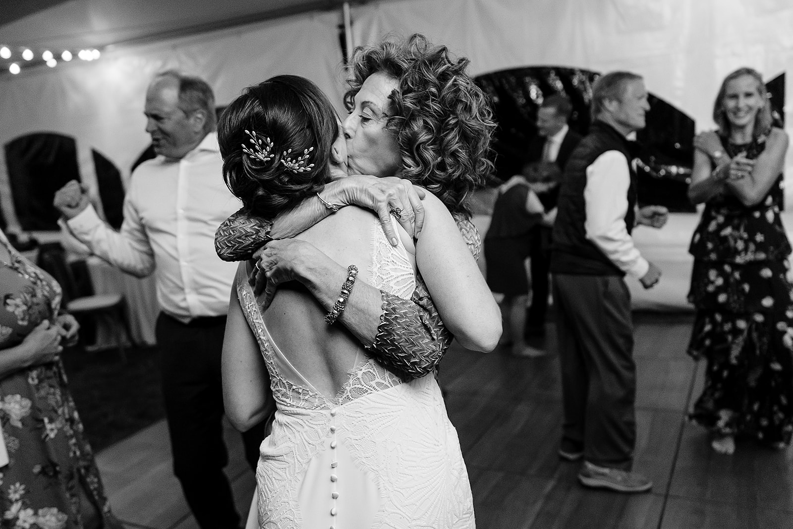 mother of the groom kisses bride on the cheek of the bride at Mazama Ranch House Wedding reception