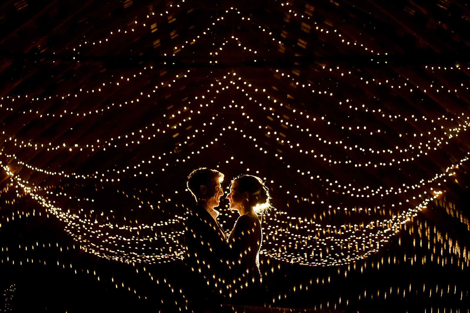 wedding portrait in Mazama Ranch House barn with string lights