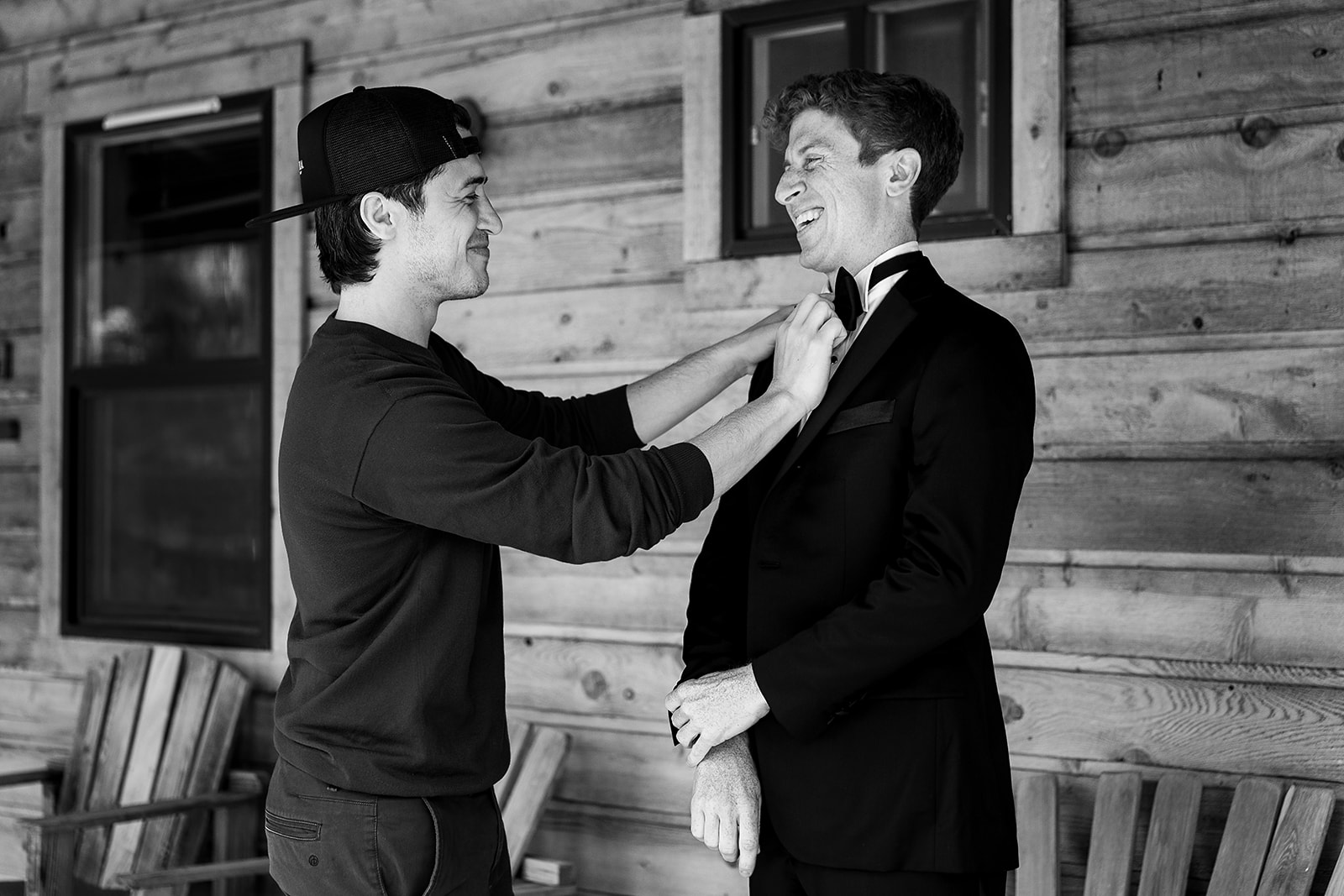 brother of the groom helps groom tie bowtie at Mazama Ranch House Wedding