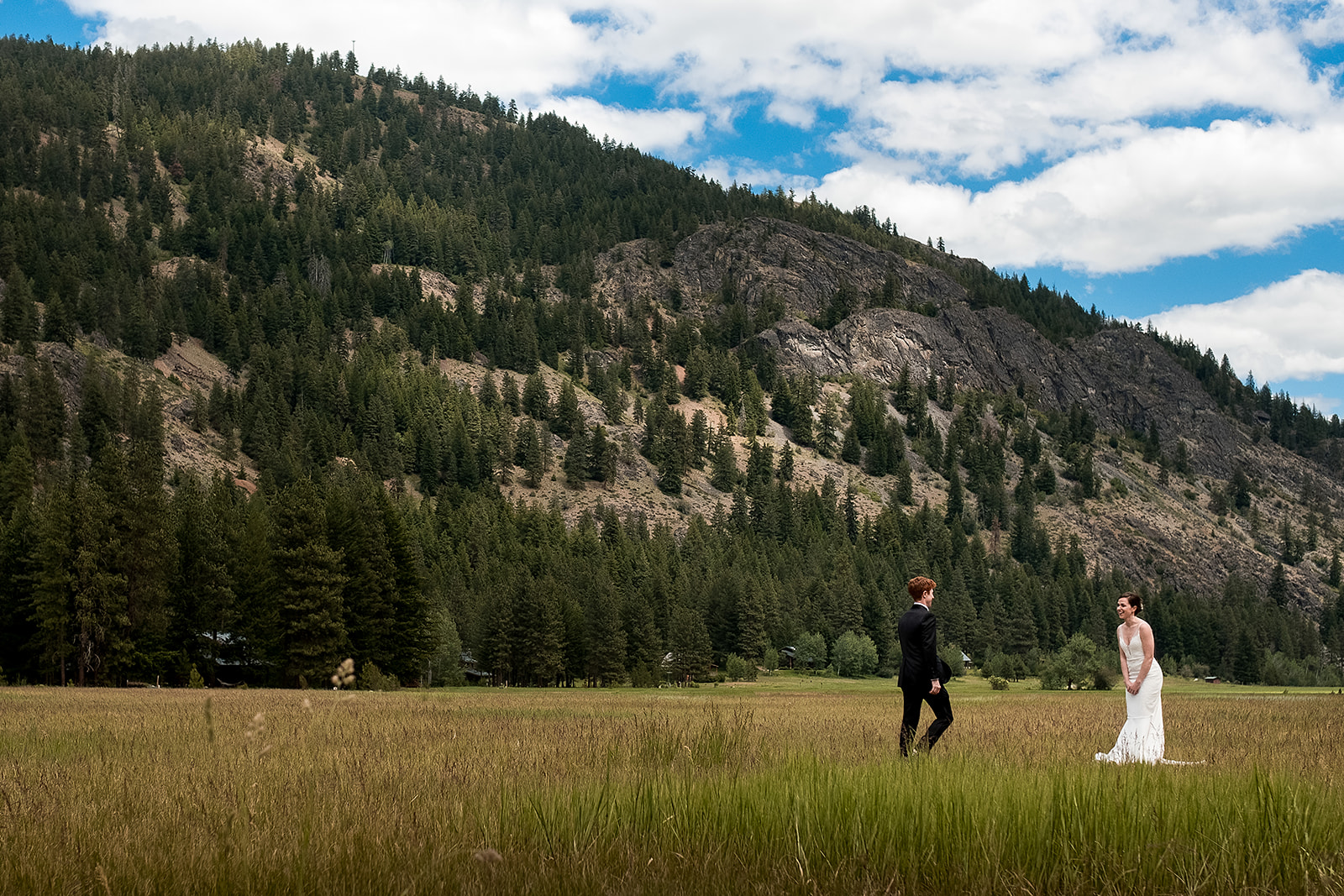 groom walks toward bride after first look in the methow valley