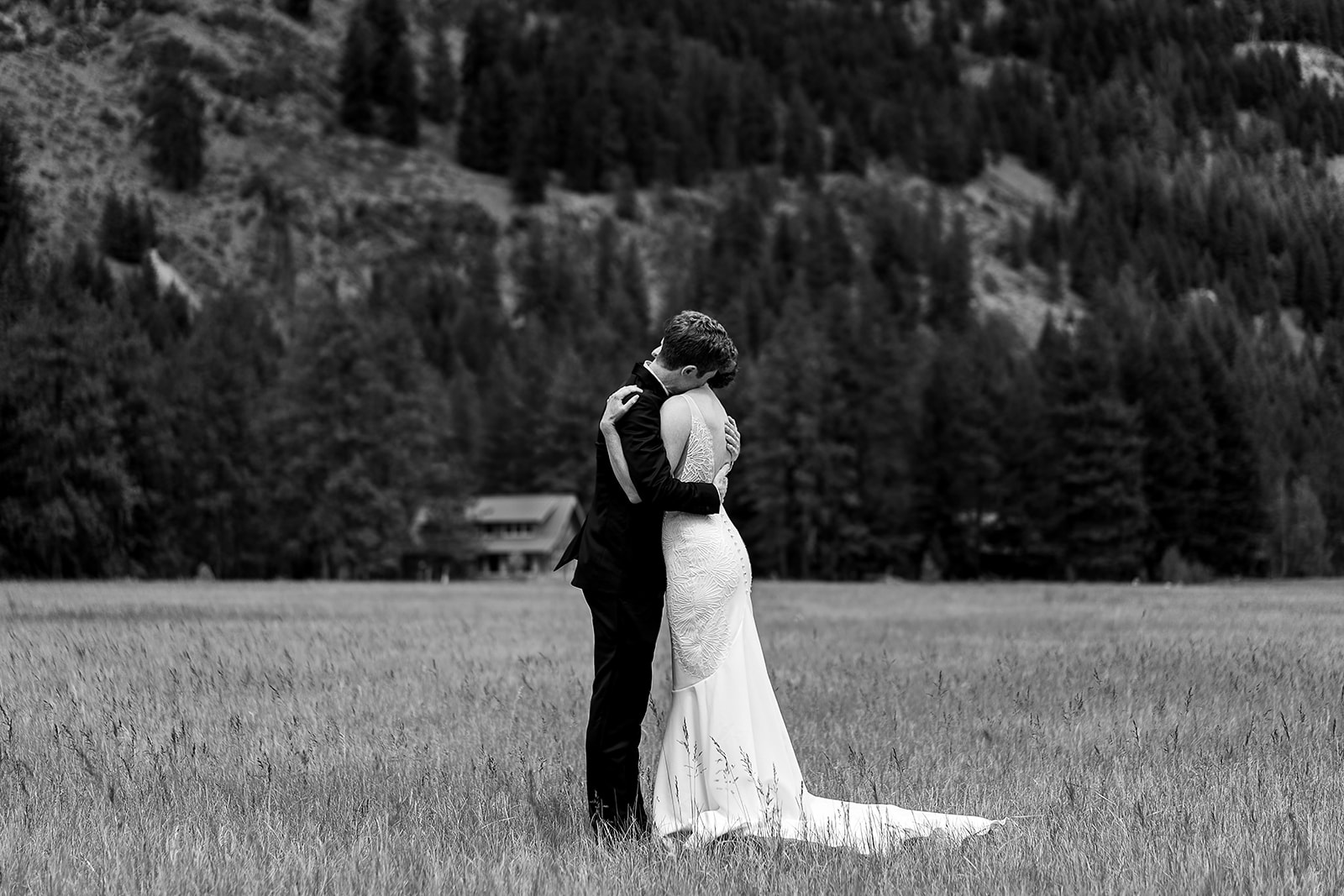 bride and groom embrace during first look at Mazama Ranch House Wedding