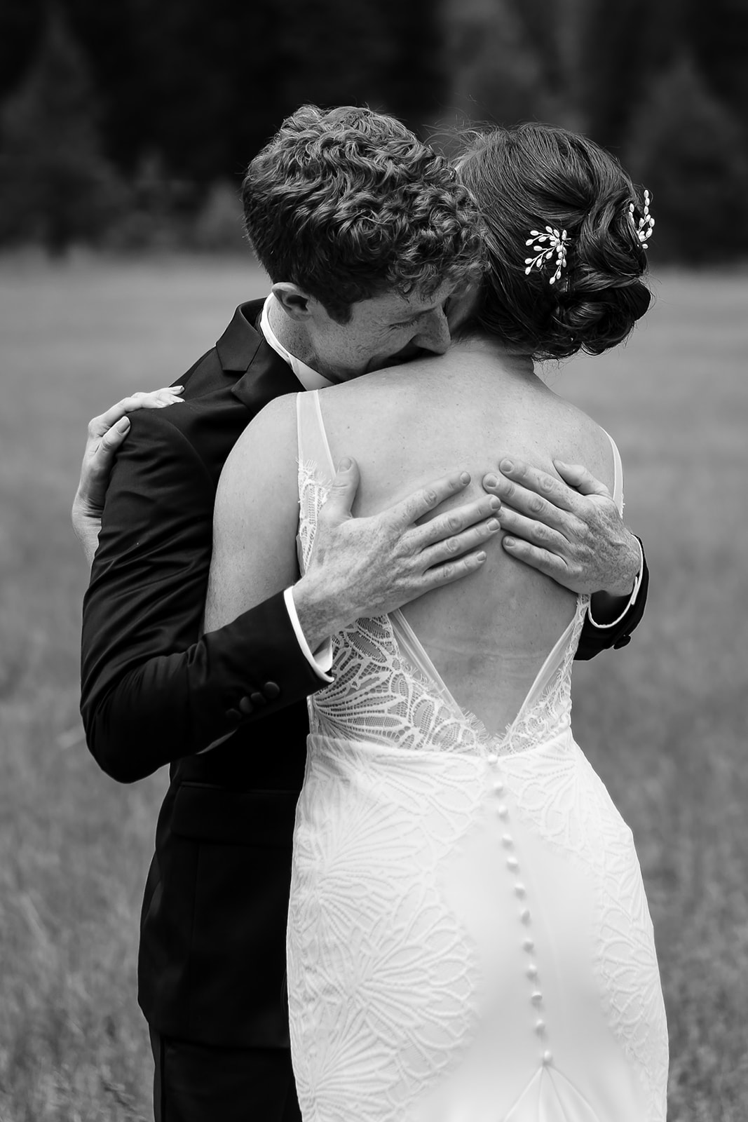 groom embraces with bride at Mazama Ranch House Wedding