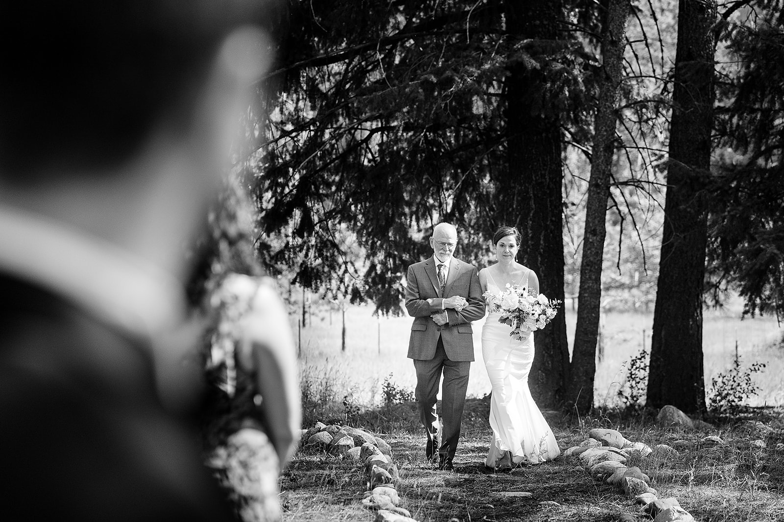 bride and father of the bride walk down the aisle during Mazama Ranch House Wedding