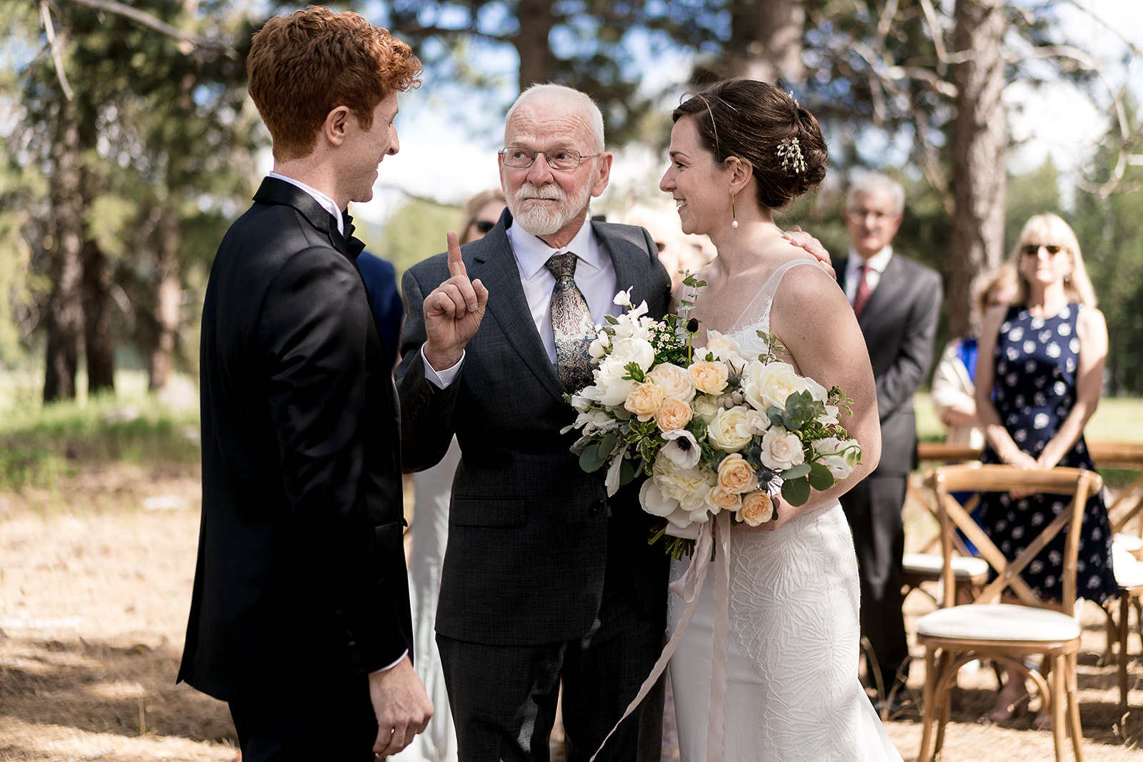 father of the bride points at groom as a joke during Mazama Ranch House Wedding
