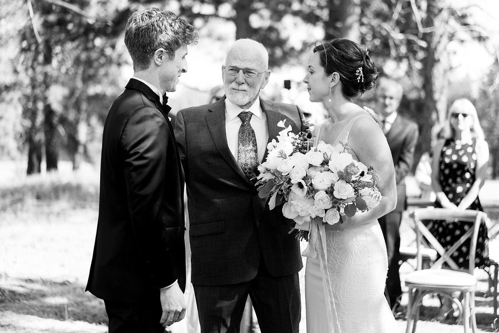father of the groom struggles to not cry when hanging bride off to groom at Mazama Ranch House Wedding