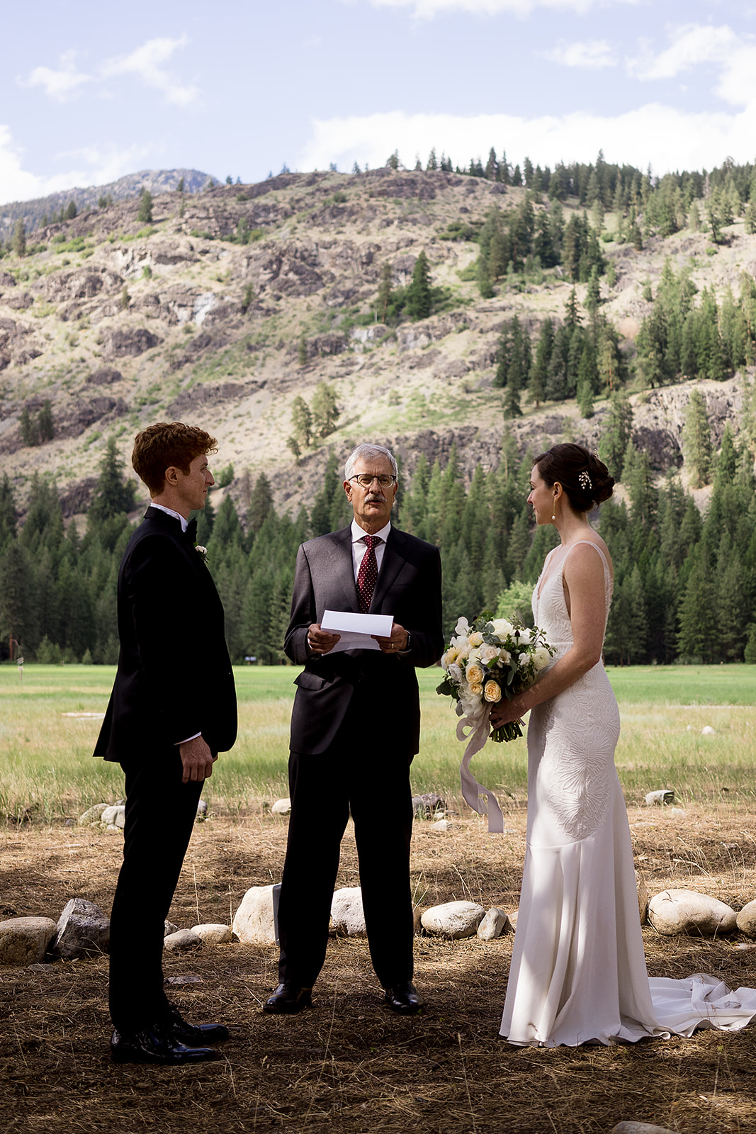 wedding guests reads prayer during Mazama Ranch House Wedding ceremony 