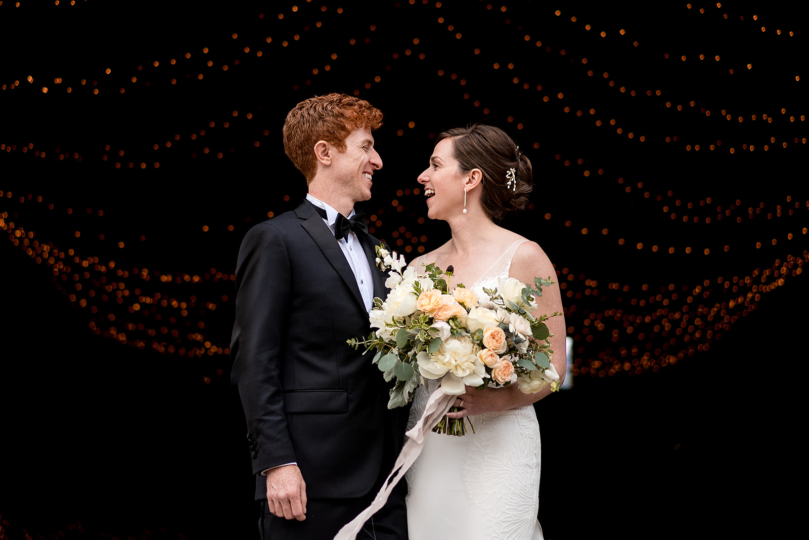 wedding portraits in barn at Mazama Ranch House with beautiful string lights