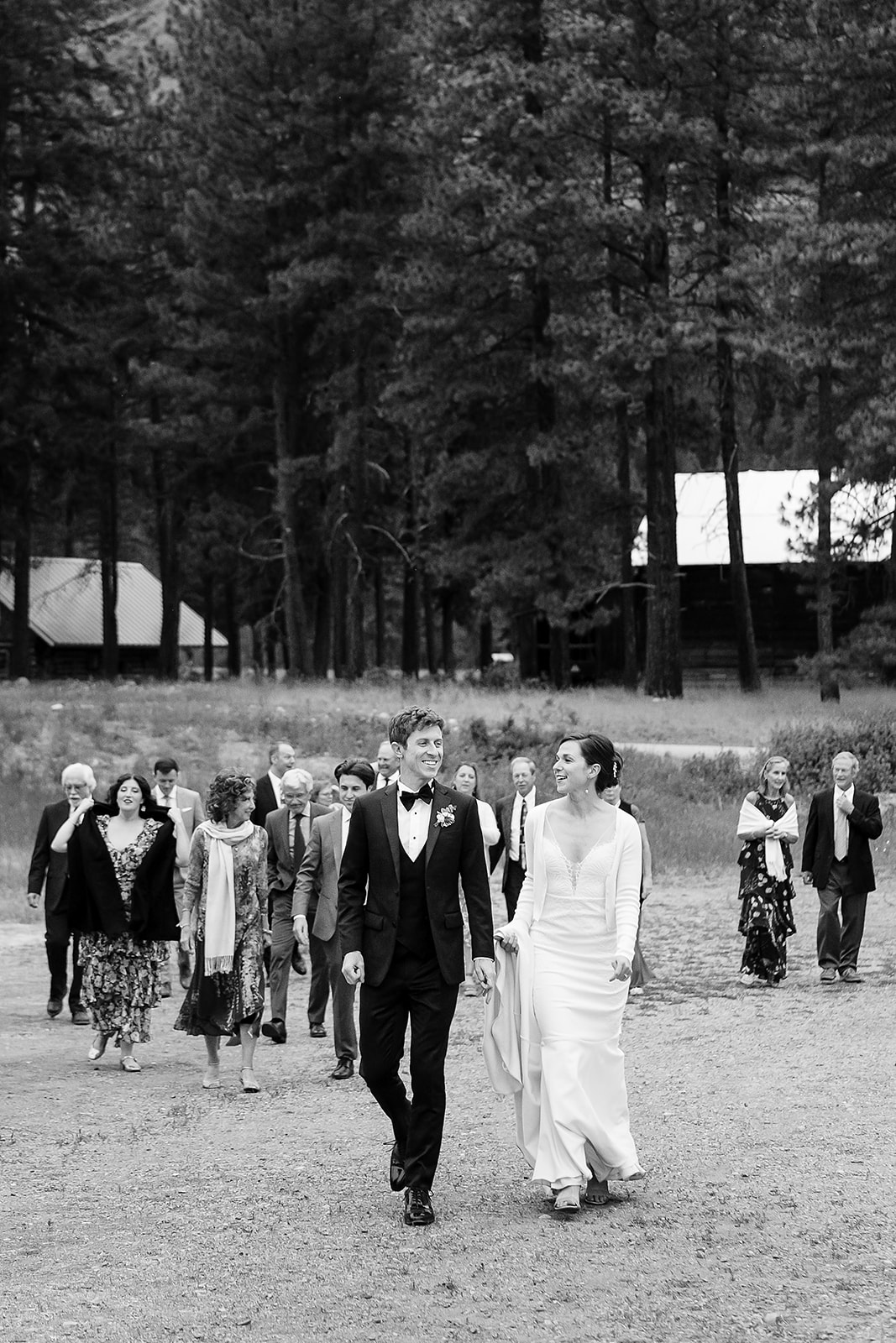 bride and groom walk with their guests to Mazama Ranch House Wedding reception