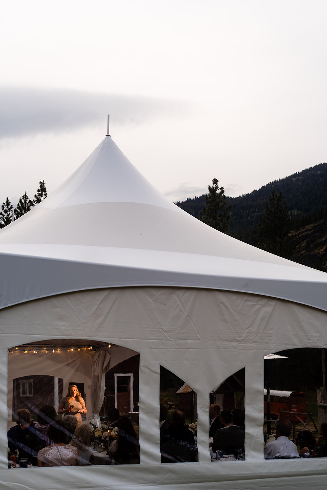 sister of the bride gives wedding toast under tent at Mazama Ranch House Wedding reception