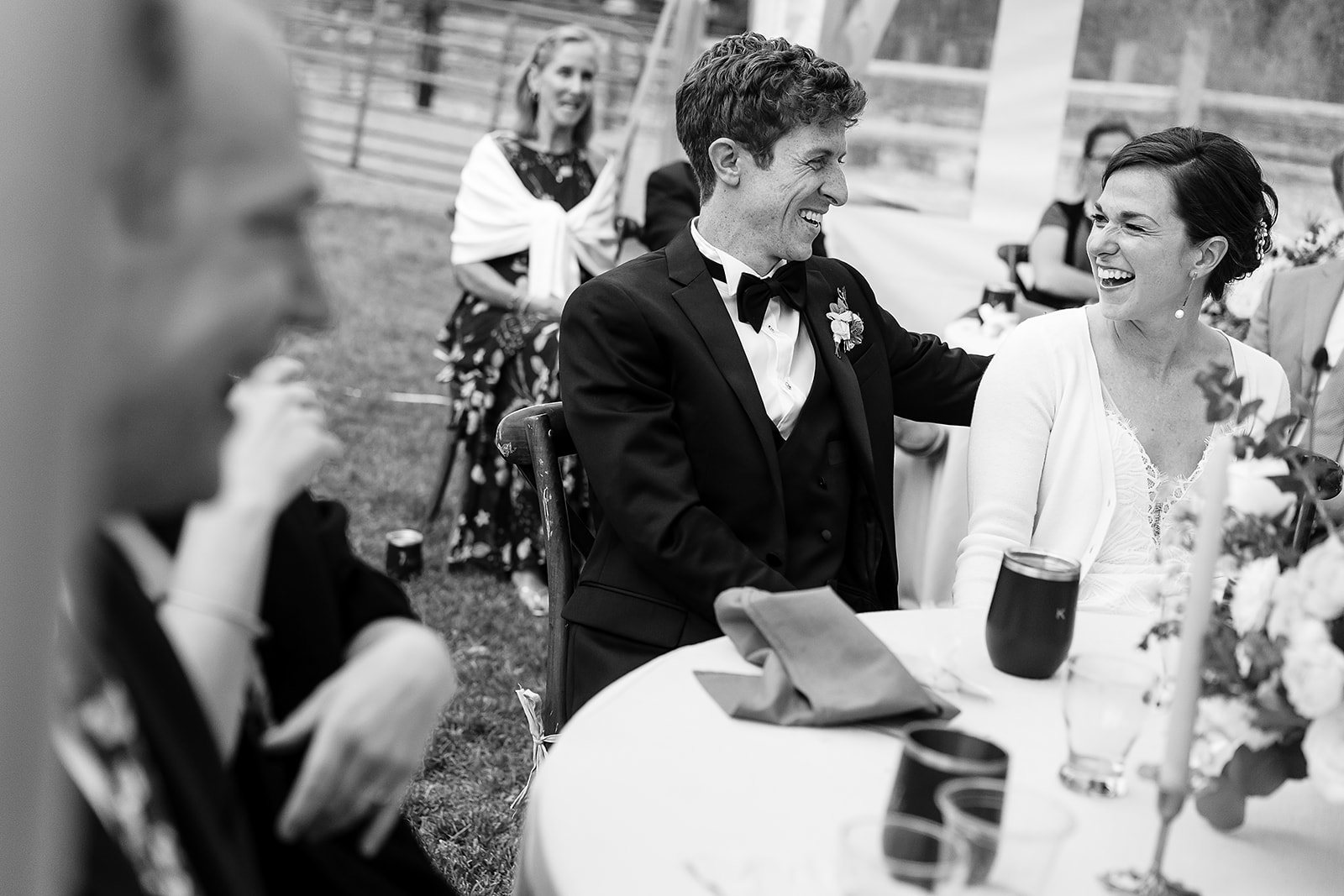 bride and groom look at each other while laughing during Mazama Ranch House Wedding reception