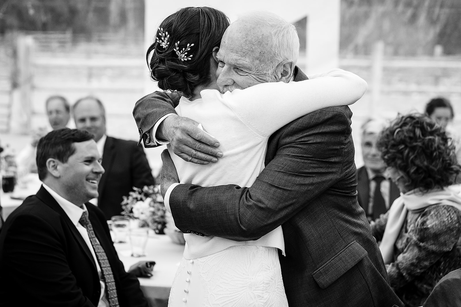 father of the bride gives the bride a huge hug during Mazama Ranch House Wedding reception