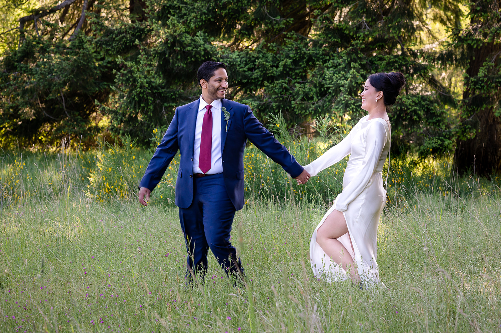 photo of Bride and Groom laughing in the grasses at Rathtrevor Beach on Vancouver Island