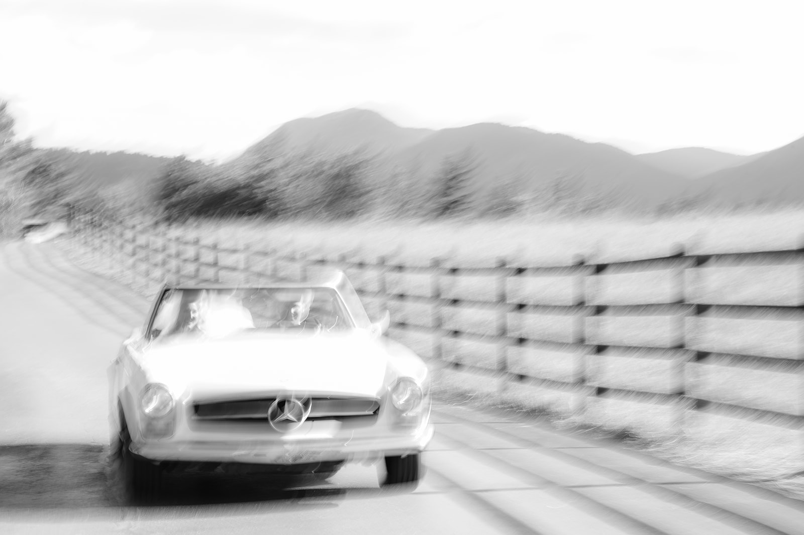 Couple in their vintage Mercedes Bez driving on wedding day at Spruce Mountain Ranch. 