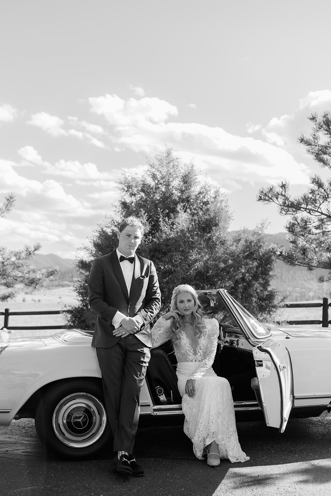 Couple in their vintage Mercedes Bez driving on wedding day at Spruce Mountain Ranch. 