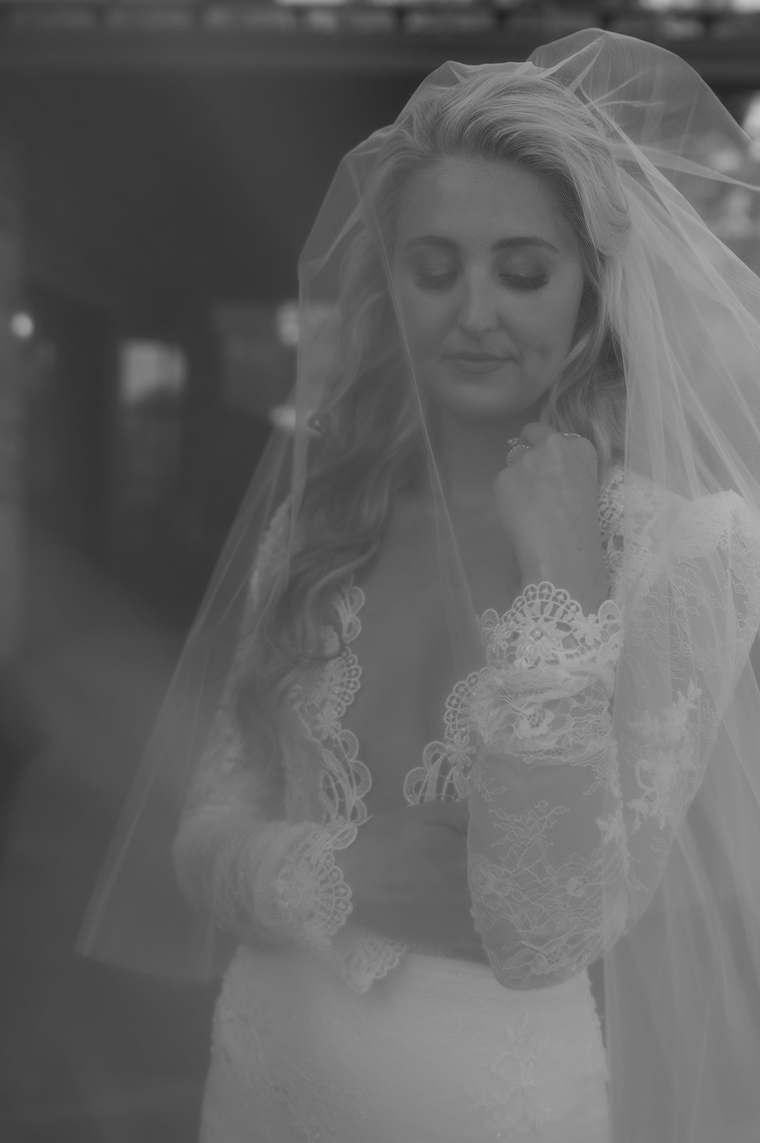 Artistic Black and White image of bride through her veil.