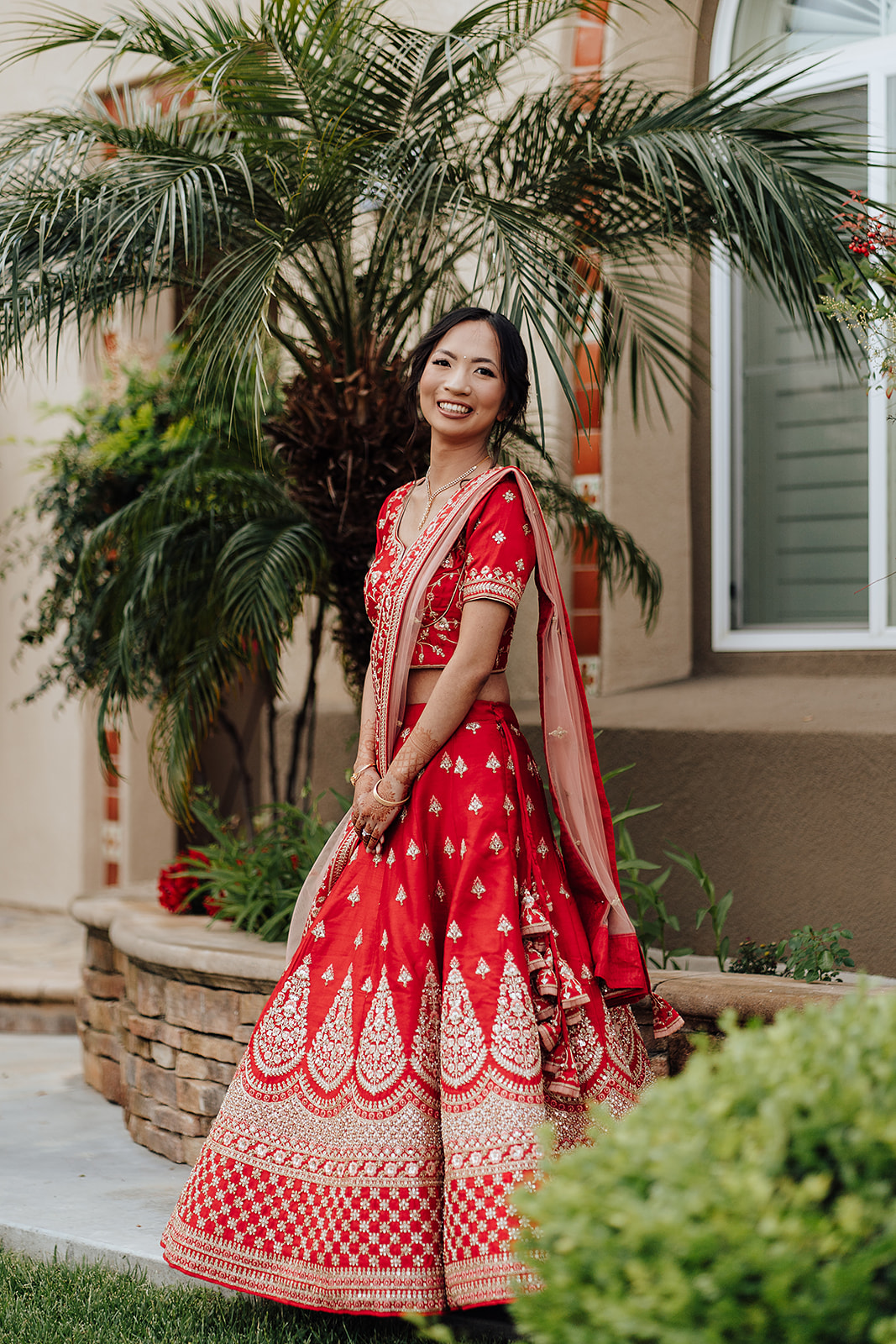 Chinese bride dressed in traditional indian wedding gown in Orange County California