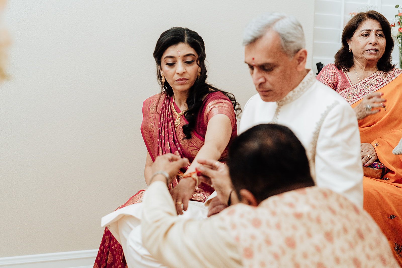 Indian wedding in Orange County California mother and father of the groom perform traditional wedding rituals