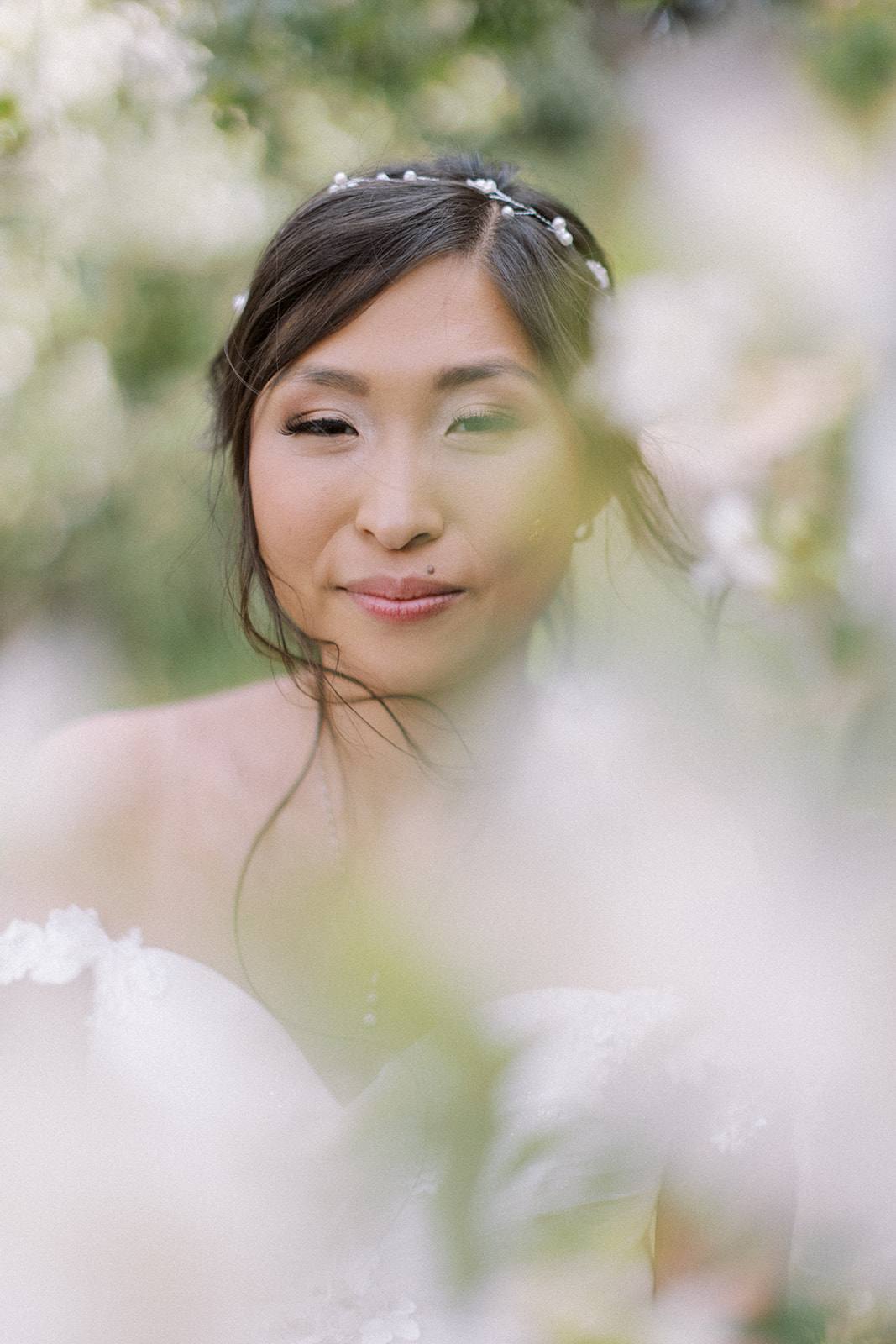 Portrait of bride with spring blooms in Manito Park in Spokane, Washington