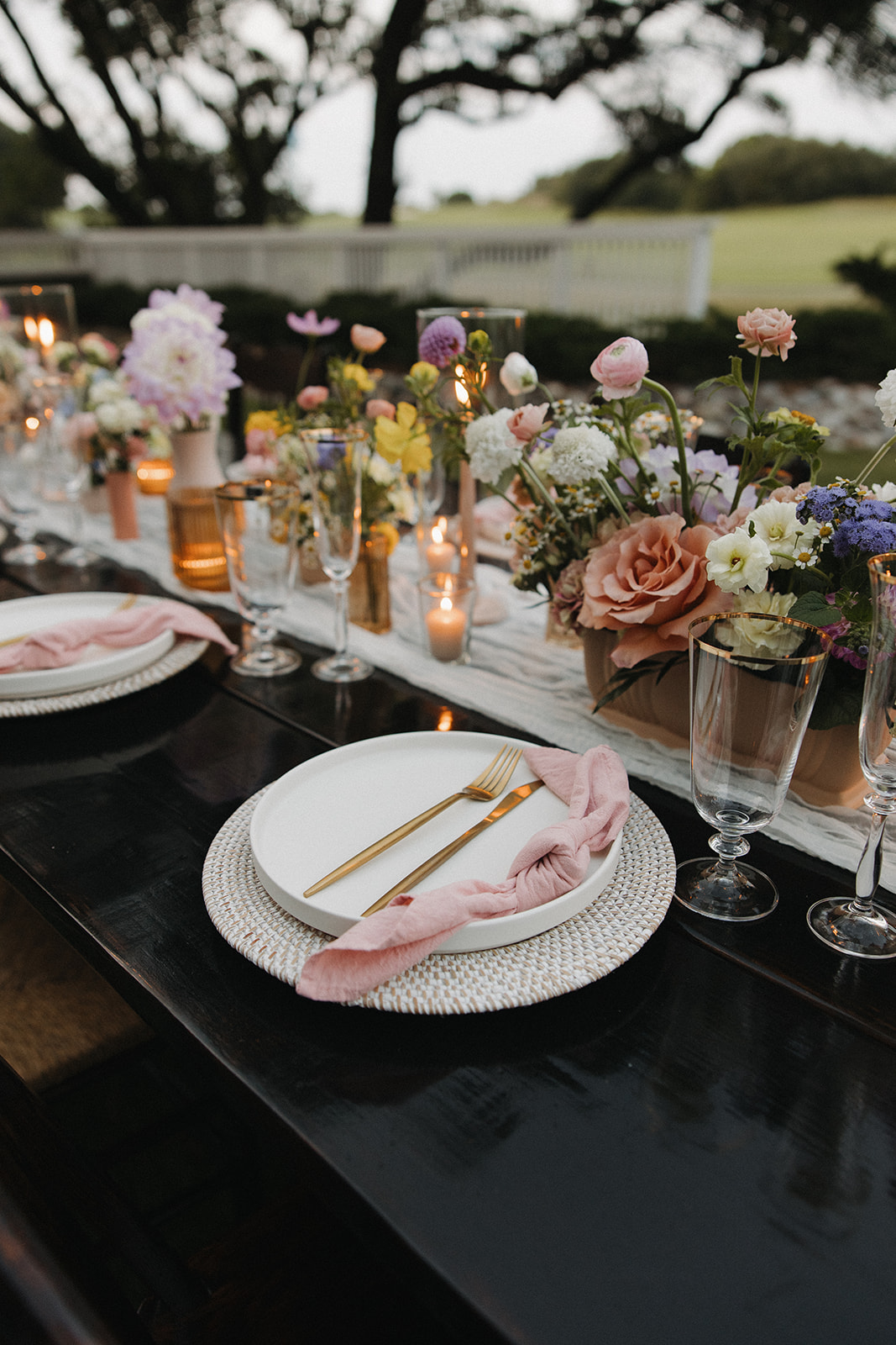 floral decor and table settings at backyard wedding reception