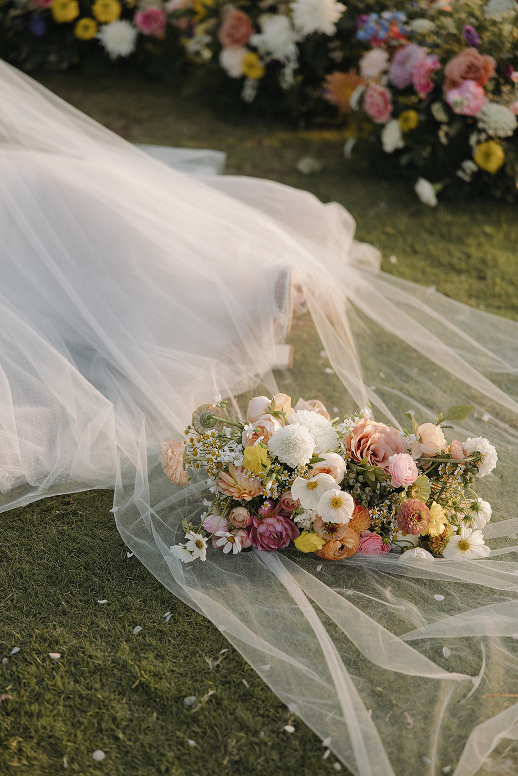 wedding bouquet sits on wedding dress veil