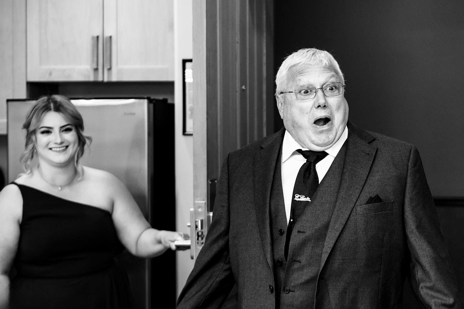 BW photograph of a dad reacting to his daughter in her wedding dress