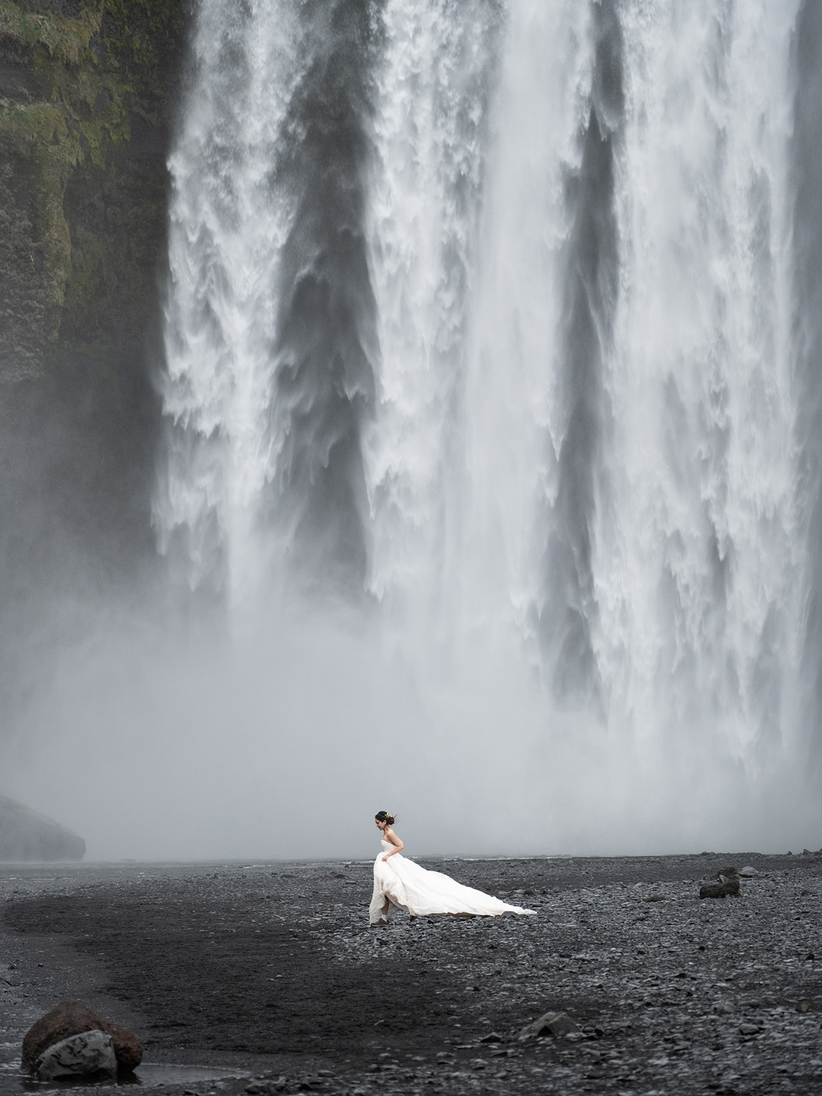 bride running in front of skogafoss waterfall iceland 
