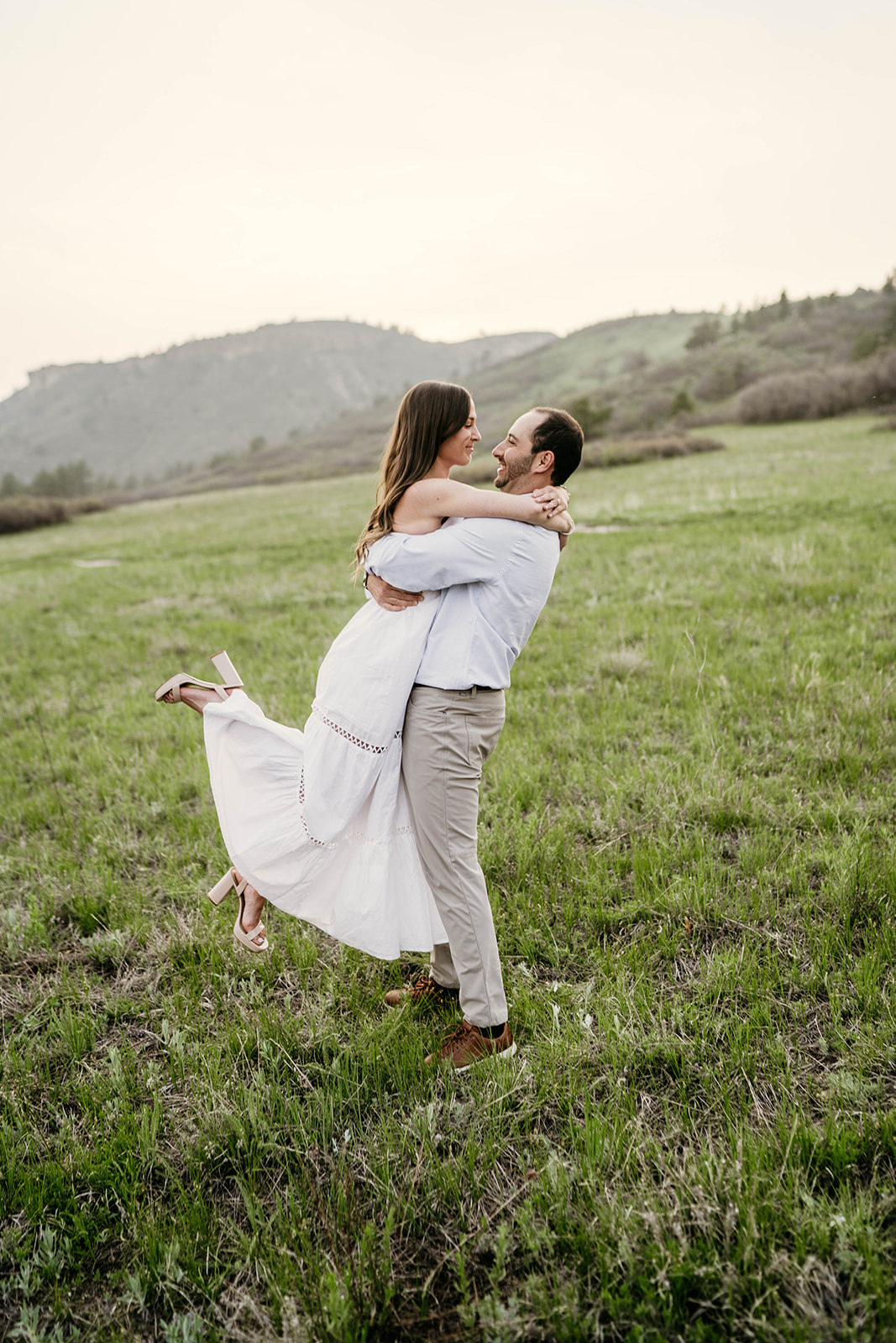 A couple dancing around in a beautiful mountain meadow at Dawson's Butte in Castle Rock, Colorado