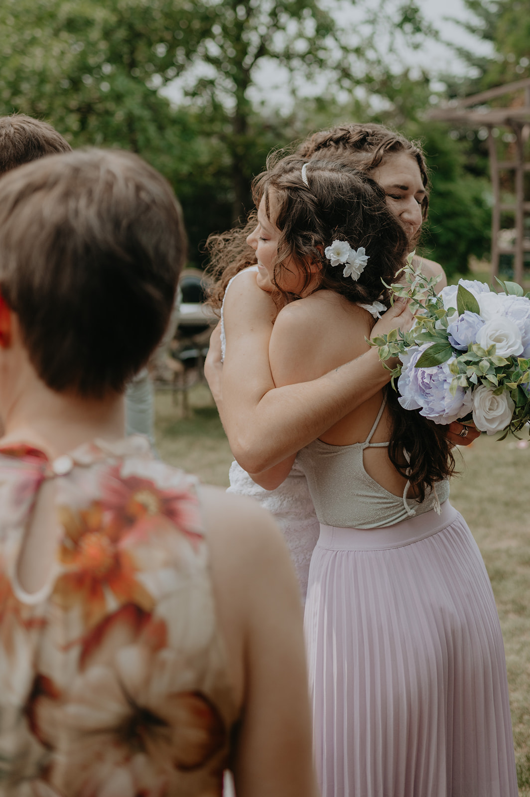 A couple says their vows in an intimate garden wedding in Edmonton, Alberta. 
