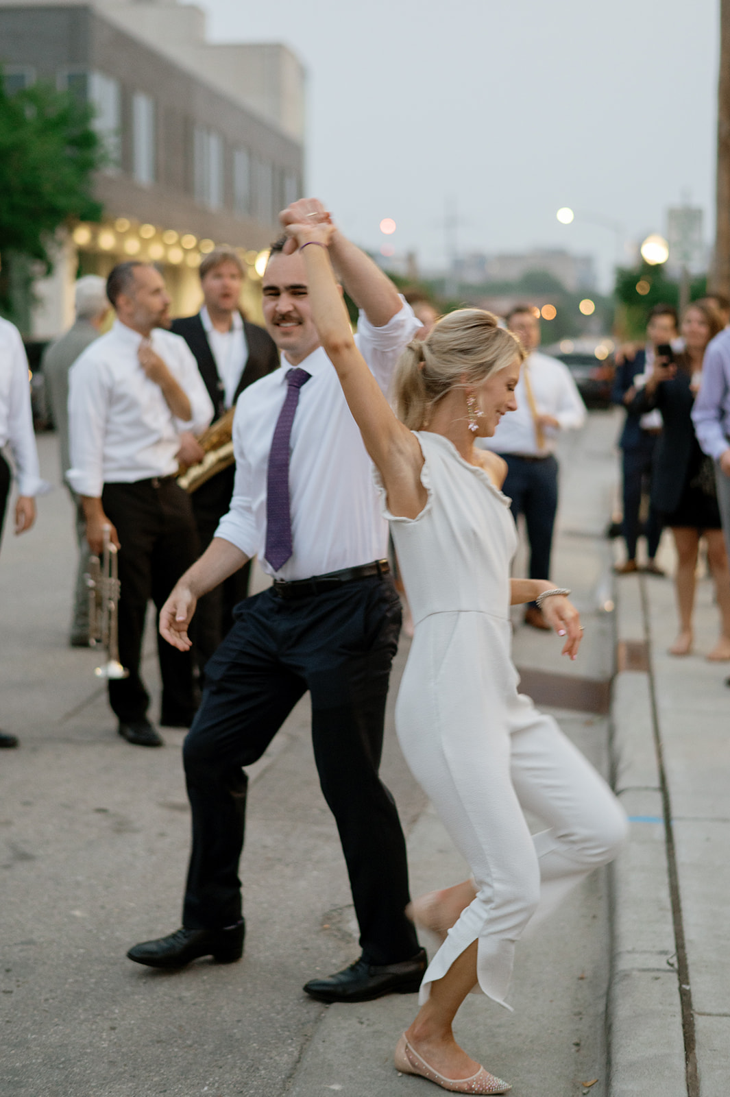 Bride and Groom dance in the streets of Madison to a brass band out side the Tinsmith